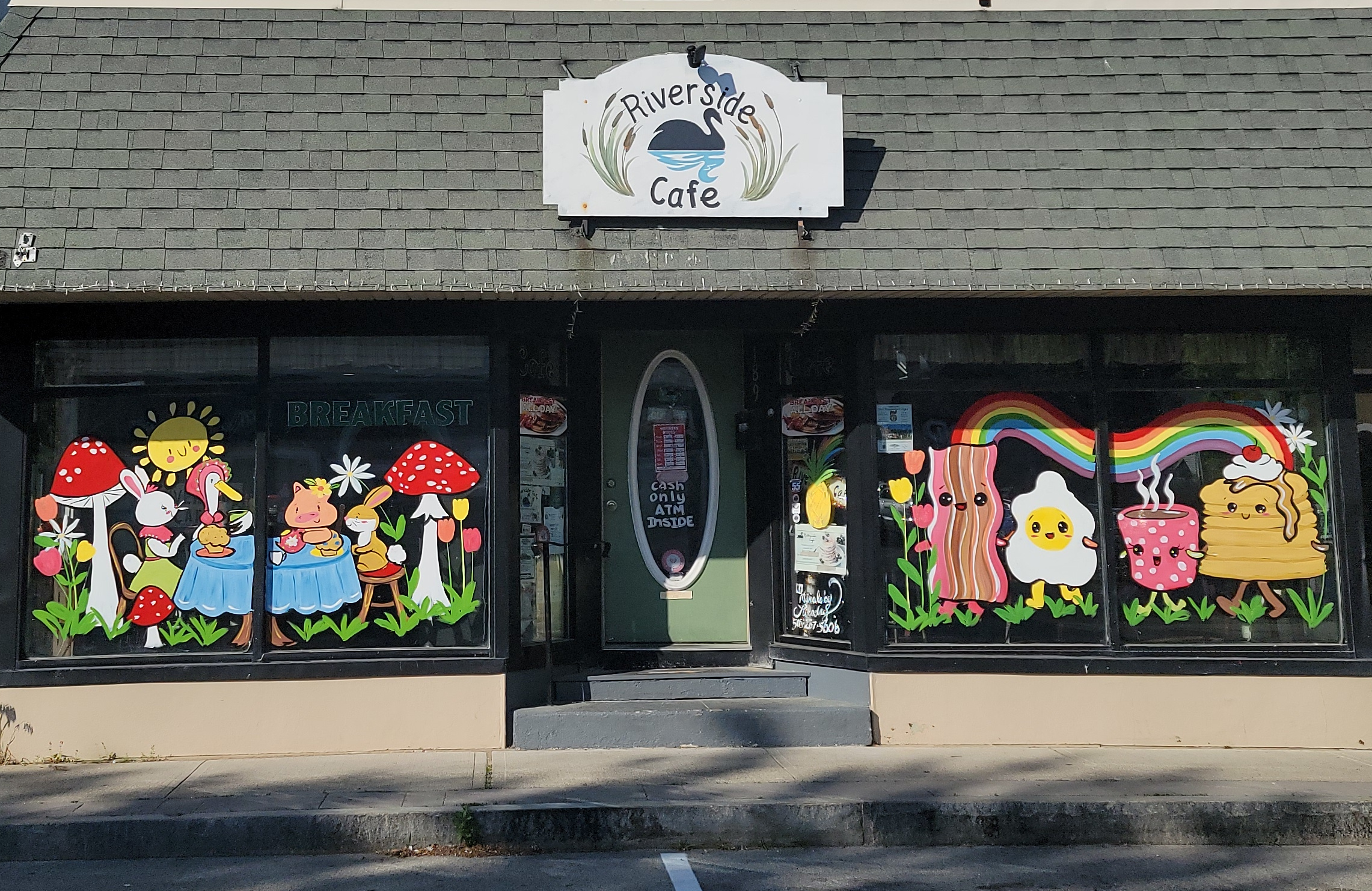 The Riverside Cafe storefront on Main Street in Wareham with hand-painted breakfast murals in the front windows